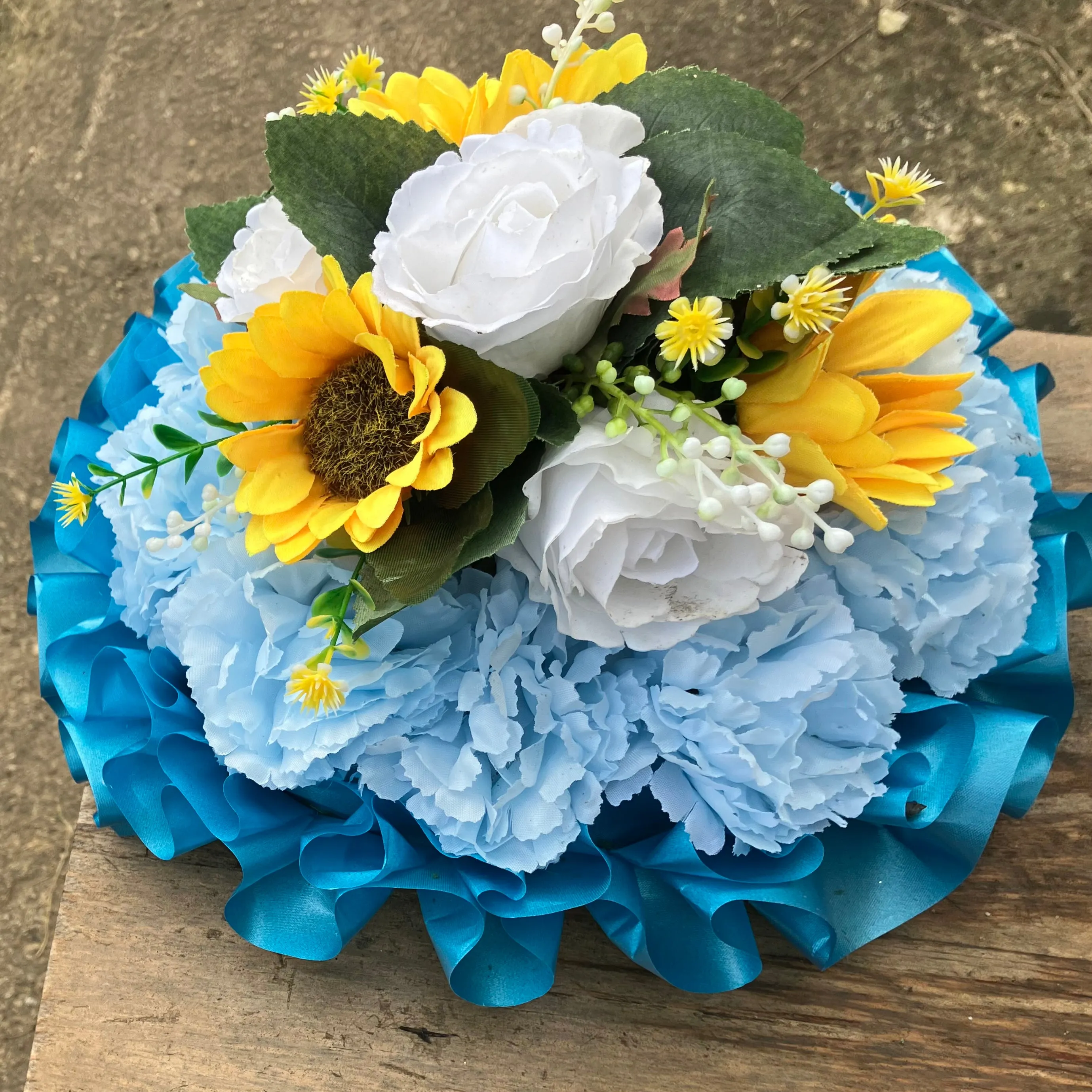 A based posy of silk roses and lily flowers in shades of blue and white